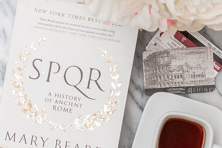 Traveling to Italy: Read These Books SPQR by Mary Beard with coffee and tickets to the Roman Colosseum