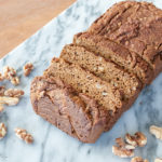 gluten free pumpkin bread loaf with walnuts on serving tray