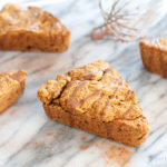 glazed pumpkin scones on marble with whisk shinewithjl