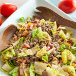 keto gluten free burger salad with tongs