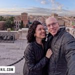 Couple at Victor Emmanuel II Monument on Day 1 of visit Rome in 1 day itinerary with the Venice Palace in background