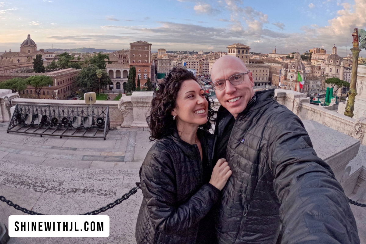 Couple at Victor Emmanuel II Monument on Day 1 of visit Rome in 1 day itinerary with the Venice Palace in background