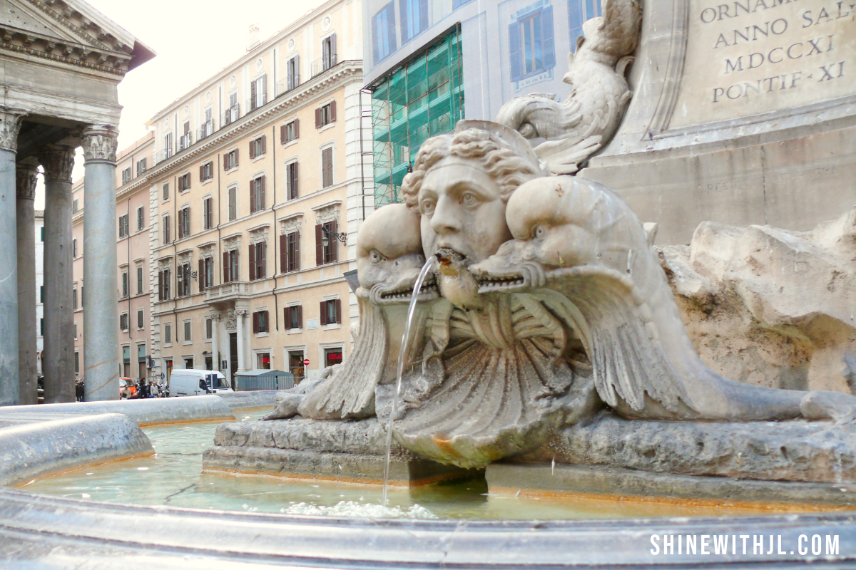 Close-up of Fontana del Pantheon sculpture in Rome, Italy with historic buildings in the background