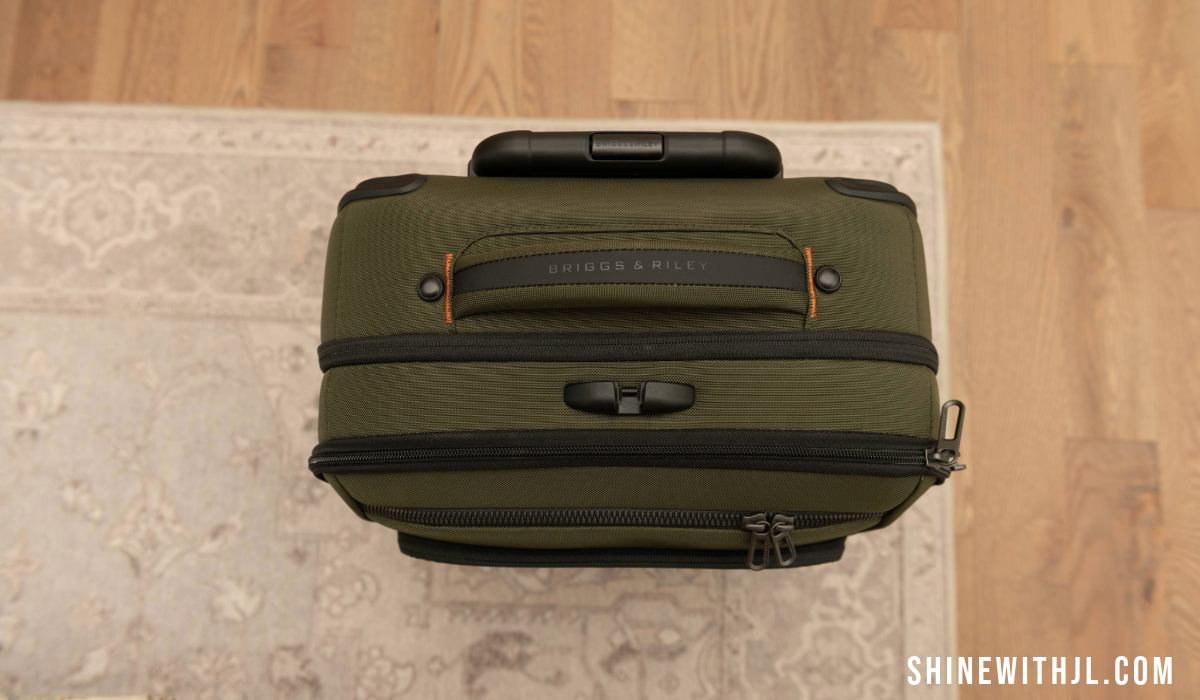 Top grab handle and zipper view of Briggs & Riley ZDX international carry-on suitcase for Italy