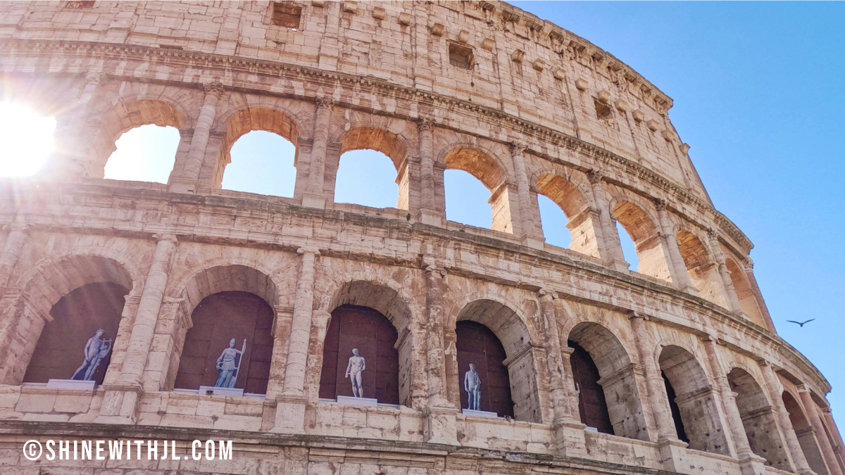Morning sunbeams shining through the Colosseum exterior on an Ancient Rome itinerary
