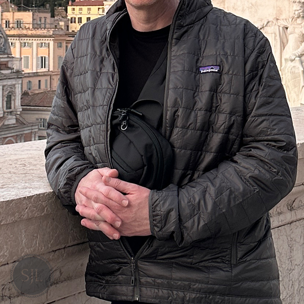 Merino wool long sleeve under Patagonia jacket used in a men's Italy spring capsule wardrobe for March travel.