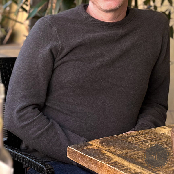 Mack Weldon crew neck sweatshirt in dark grey for chilly travel day mornings in Italy.