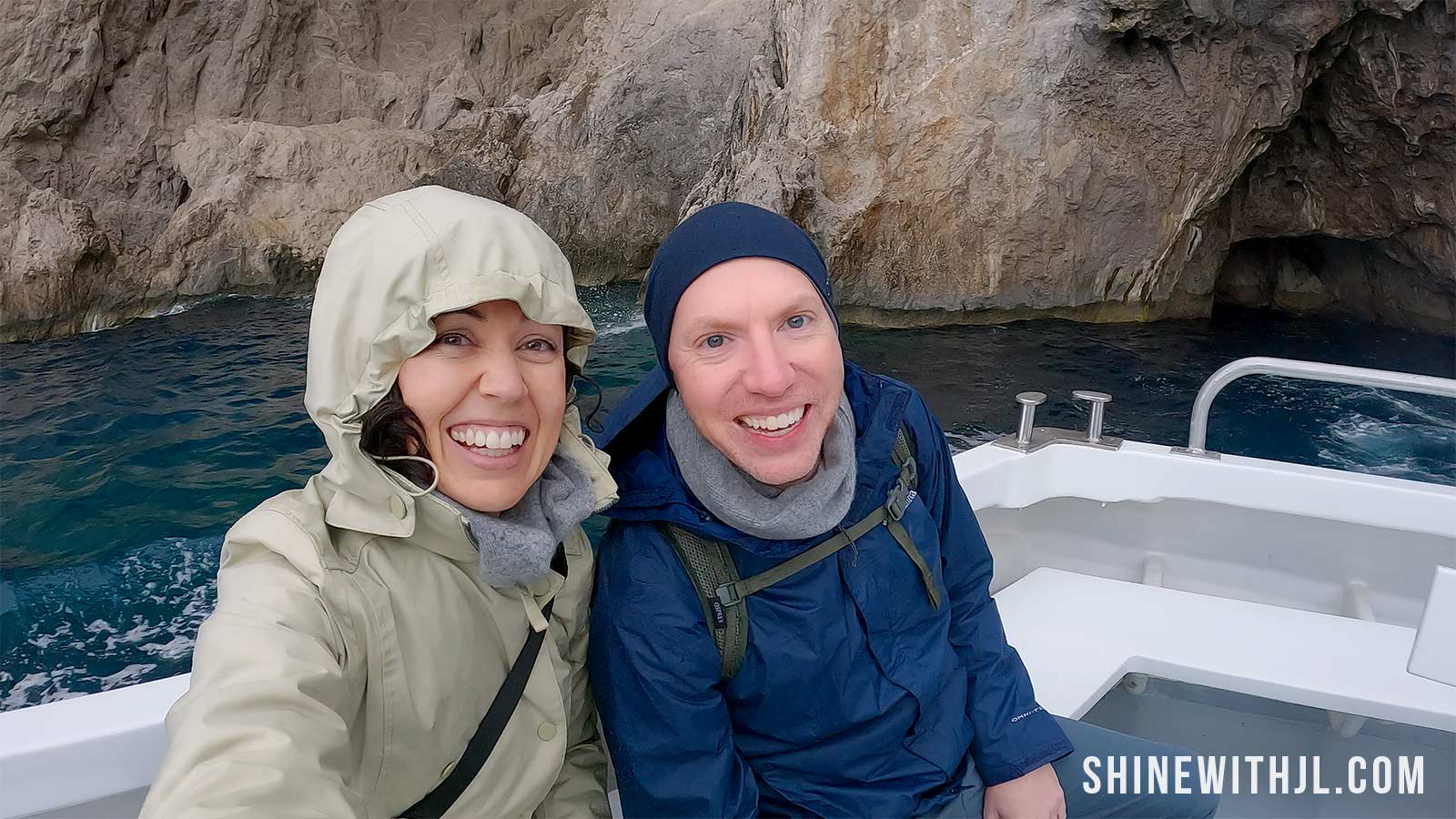 Nick and Jennifer on Laser Capri boat tour in March wearing rain jackets in Capri, Italy