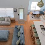 Open concept living room and kitchen inside an Anna Maria Island beach rental with cathedral ceilings and coastal decor