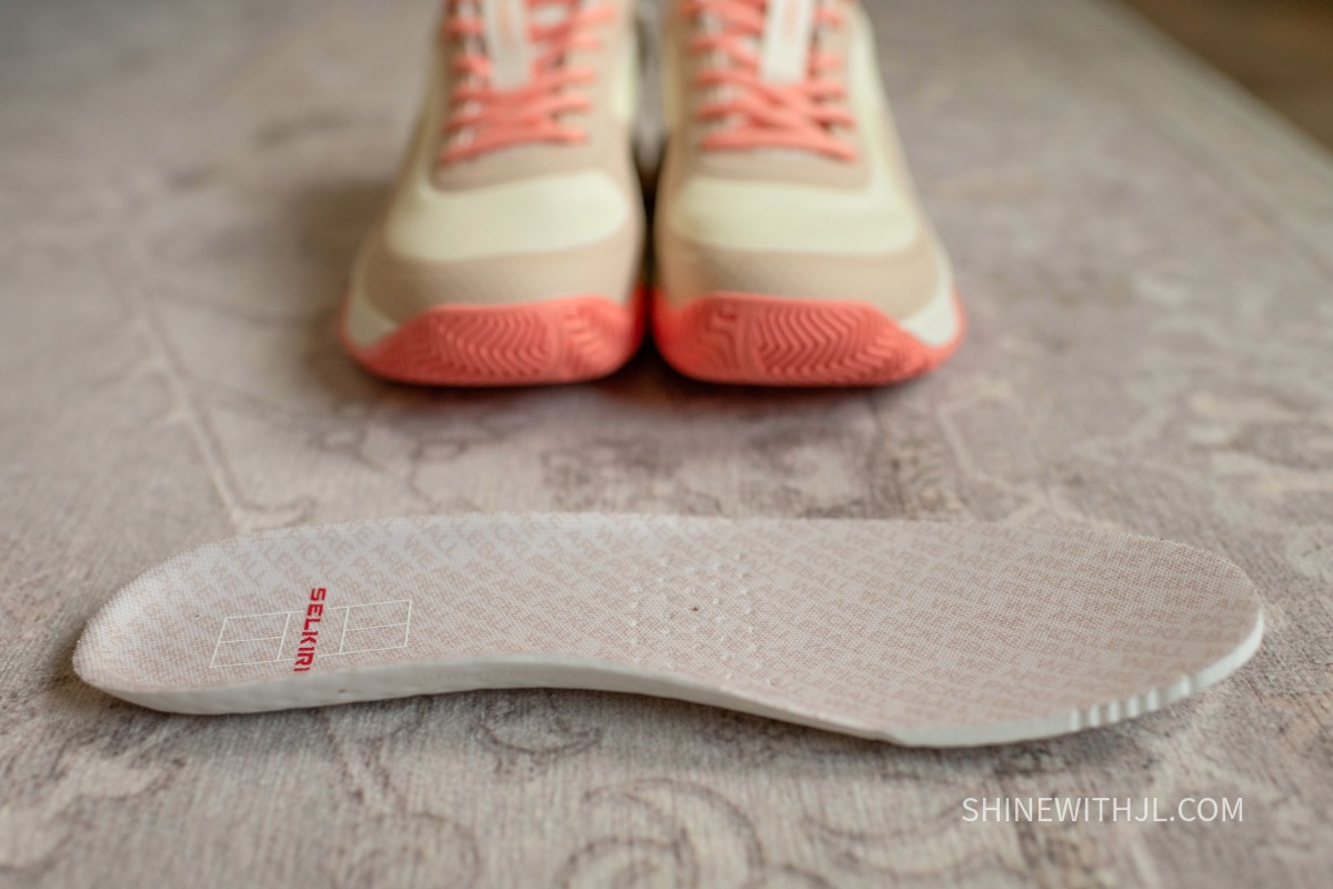 Selkirk Women’s CourtStrike Insole Insole of Selkirk CourtStrike Pro 2.0 with pickleball shoes in the background