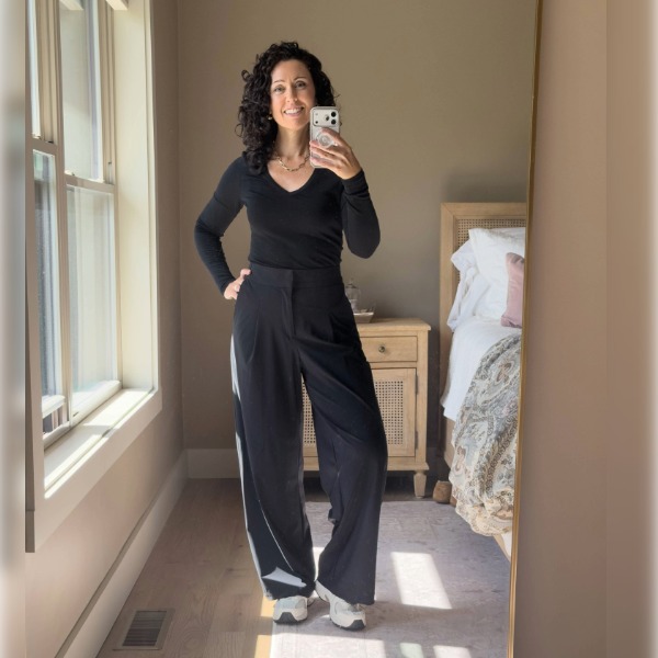 Unbound Merino Black Long-Sleeve V-Neck Black Unbound Merino long-sleeve V-neck styled with black wide leg trousers and cream sneakers